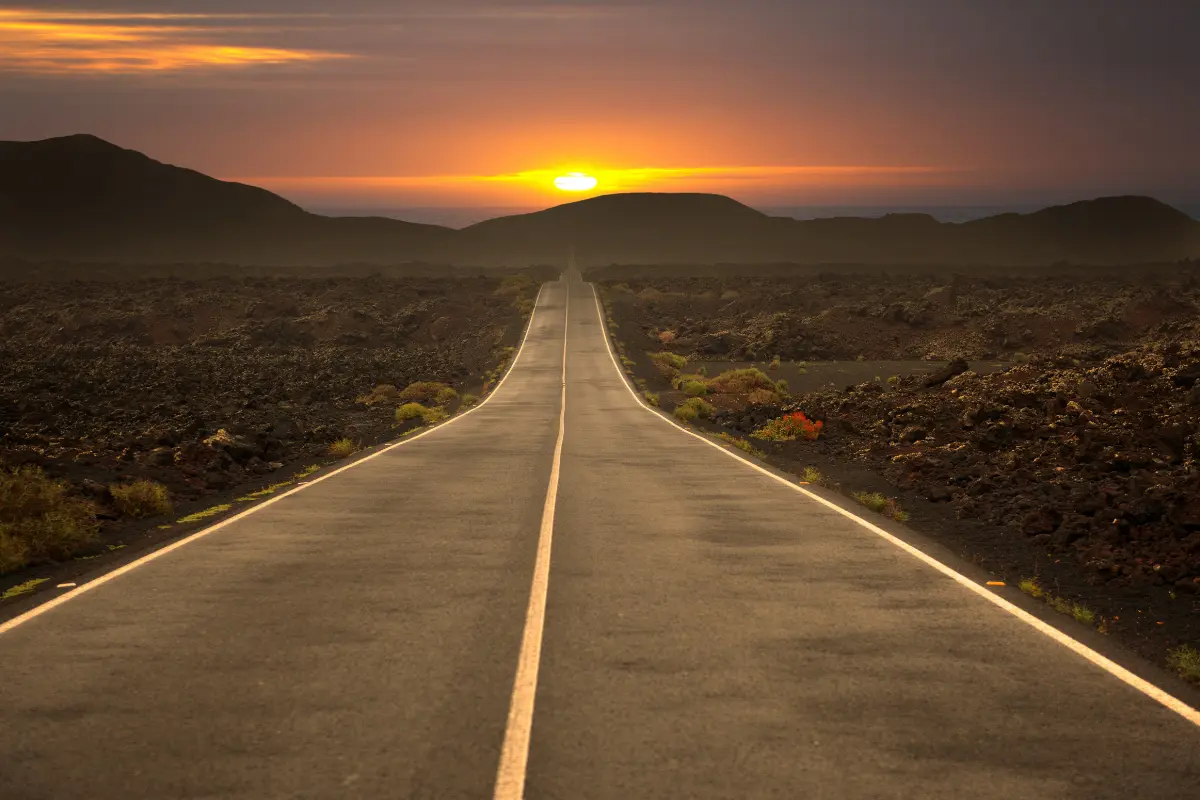 Stock image of a road fading off into the sunset